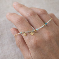 Colgante dorado piedras azules y abeja