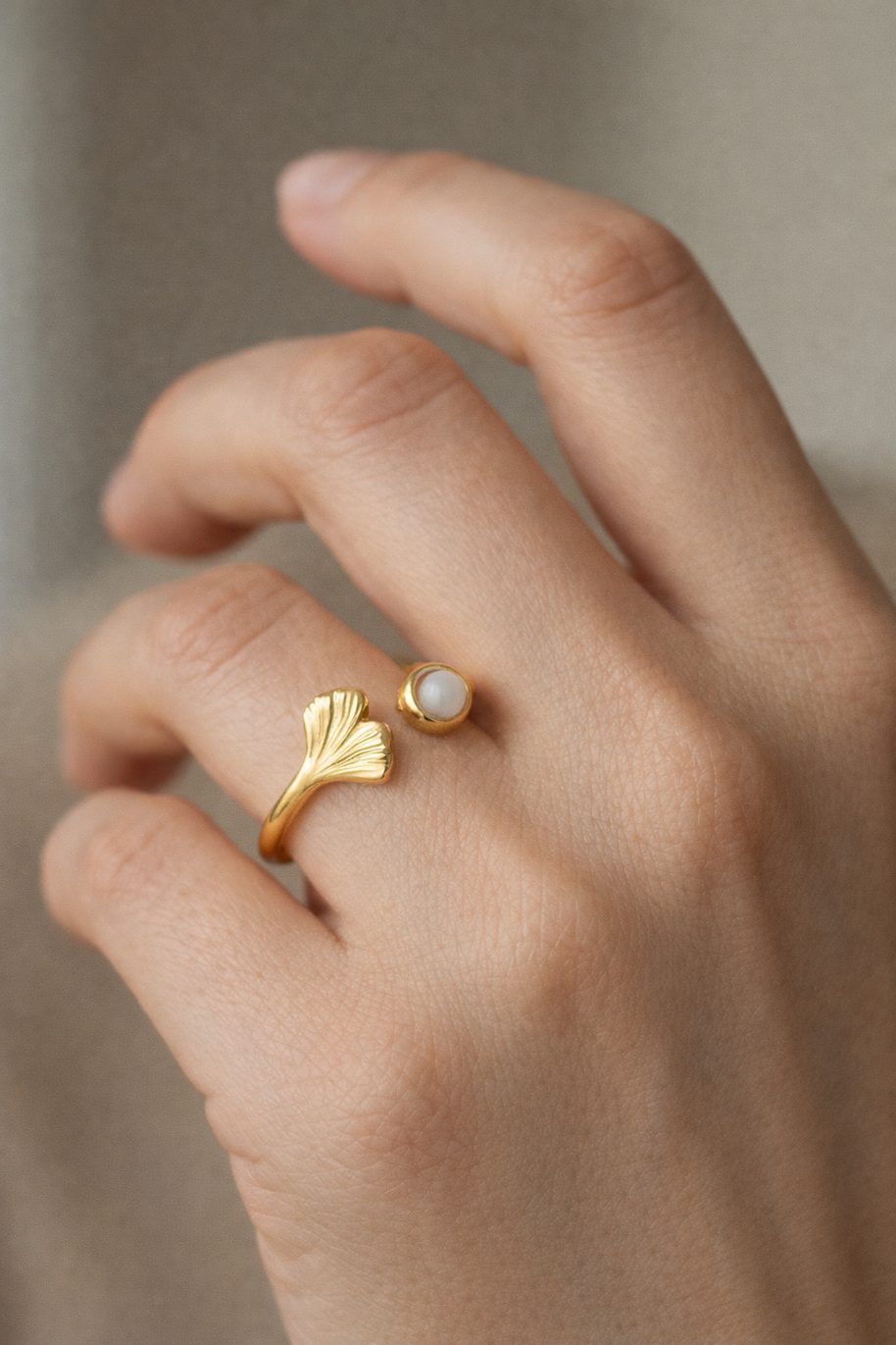 Anillo dorado con hoja de ginko y piedra