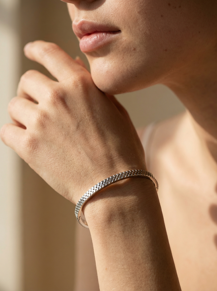 Pulsera rígida plateada tipo blazalete con borde dentado